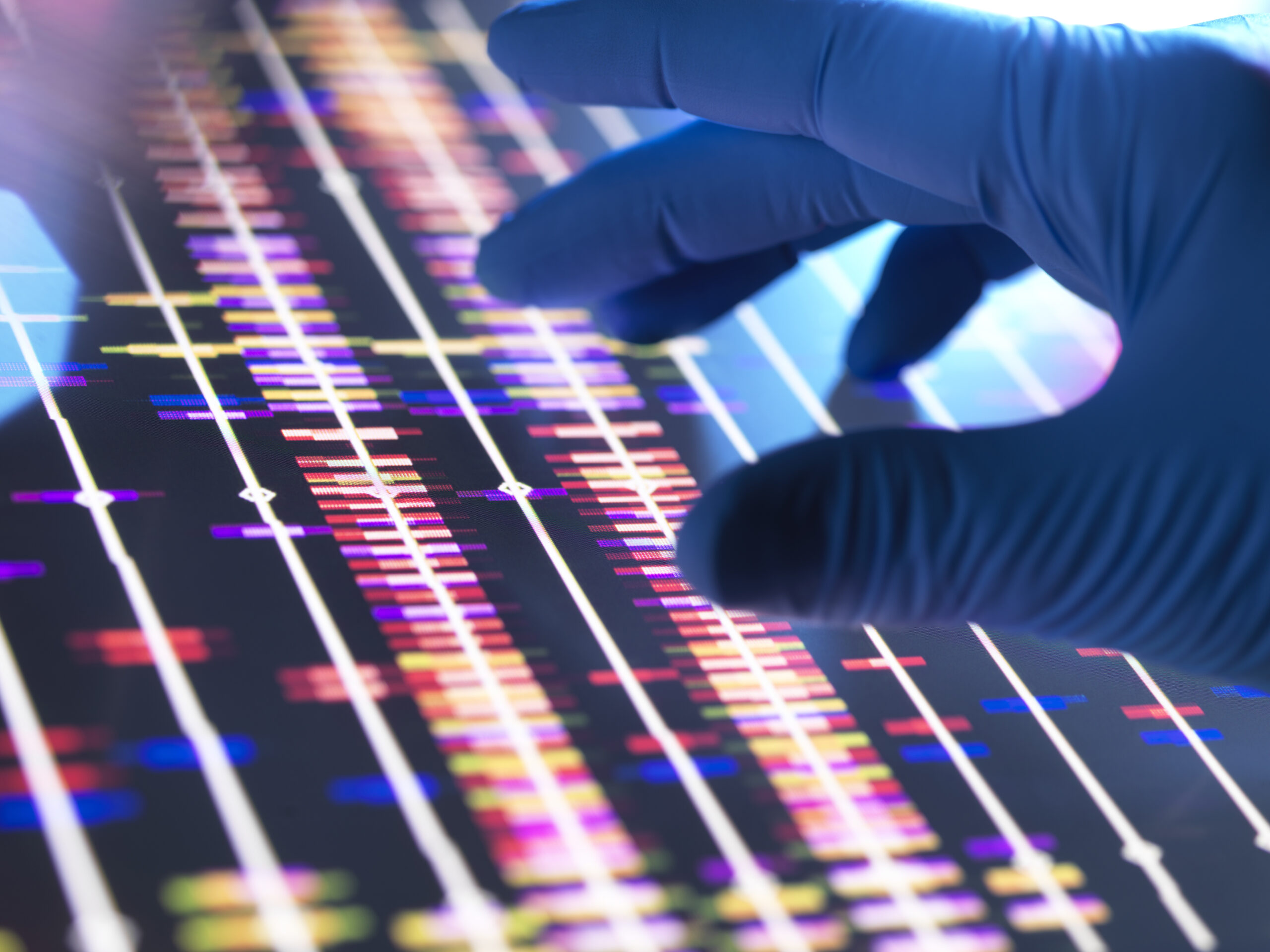 Genomic Research, Scientist examining DNA profiles after analytical testing in the lab.